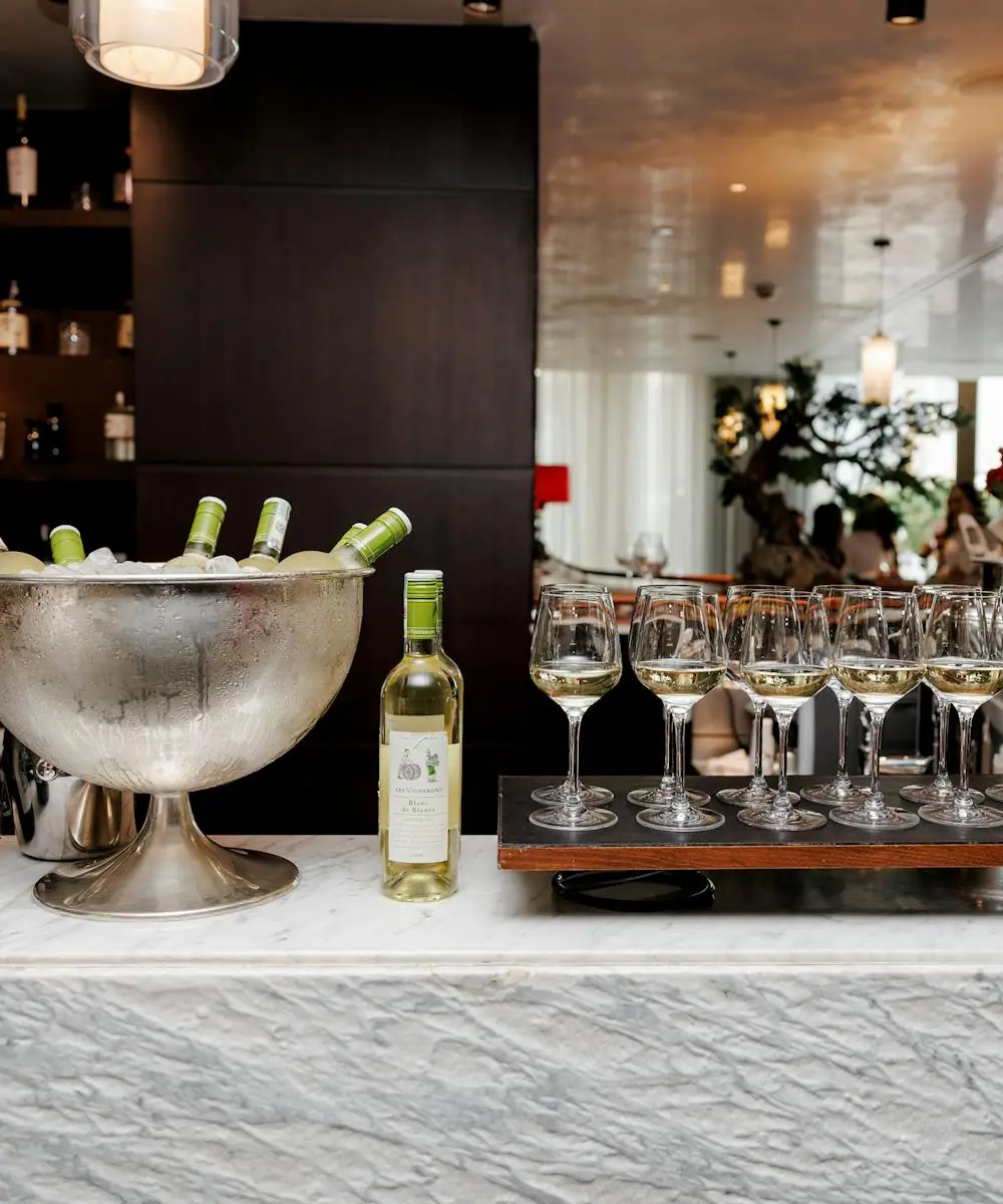 A polished brass bar cart styled with spirits, glassware, and garnishes
