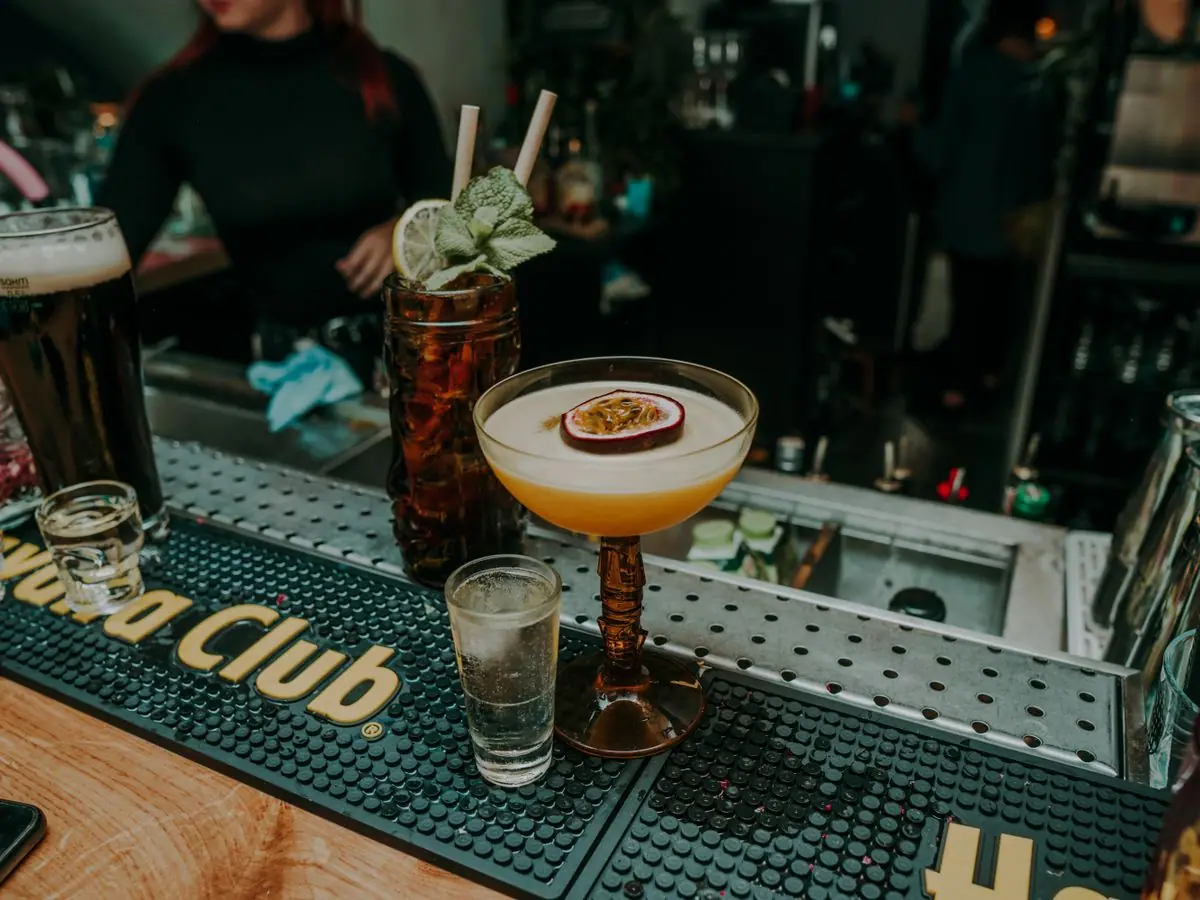 An assortment of signature cocktails arranged on a wooden bar top