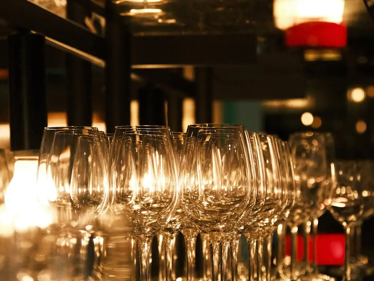 Rows of polished glassware ready for cocktail service at a bar station