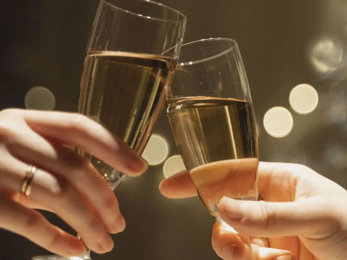 Guests raising glasses together for a celebratory toast